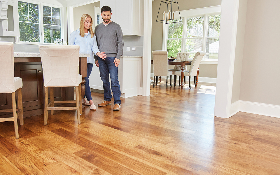 couple admiring newly installed hardwood flooring